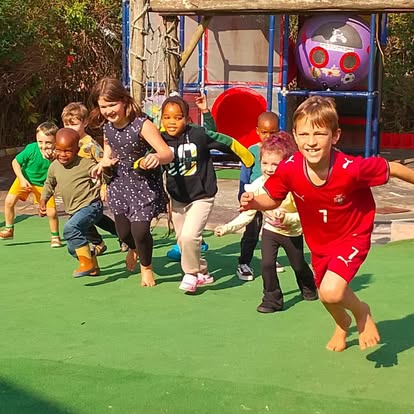 Group of children racing across the grass