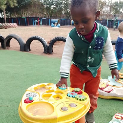 Child playing with a sensory activity table outdoors